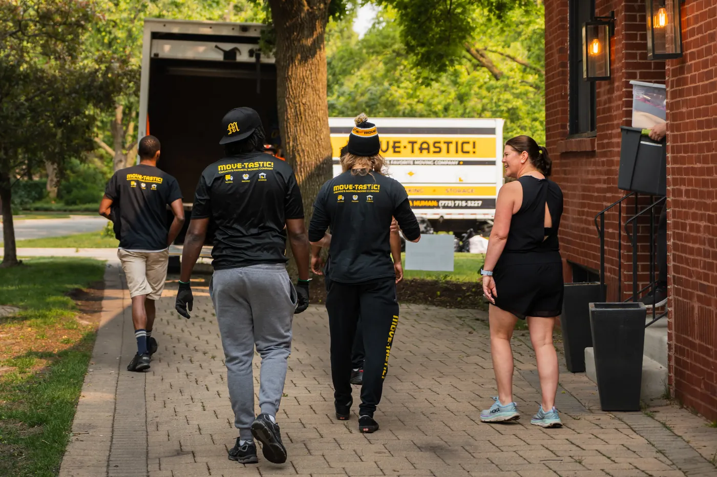 Professional moving crew gathered by their Move-Tastic truck in Chicago