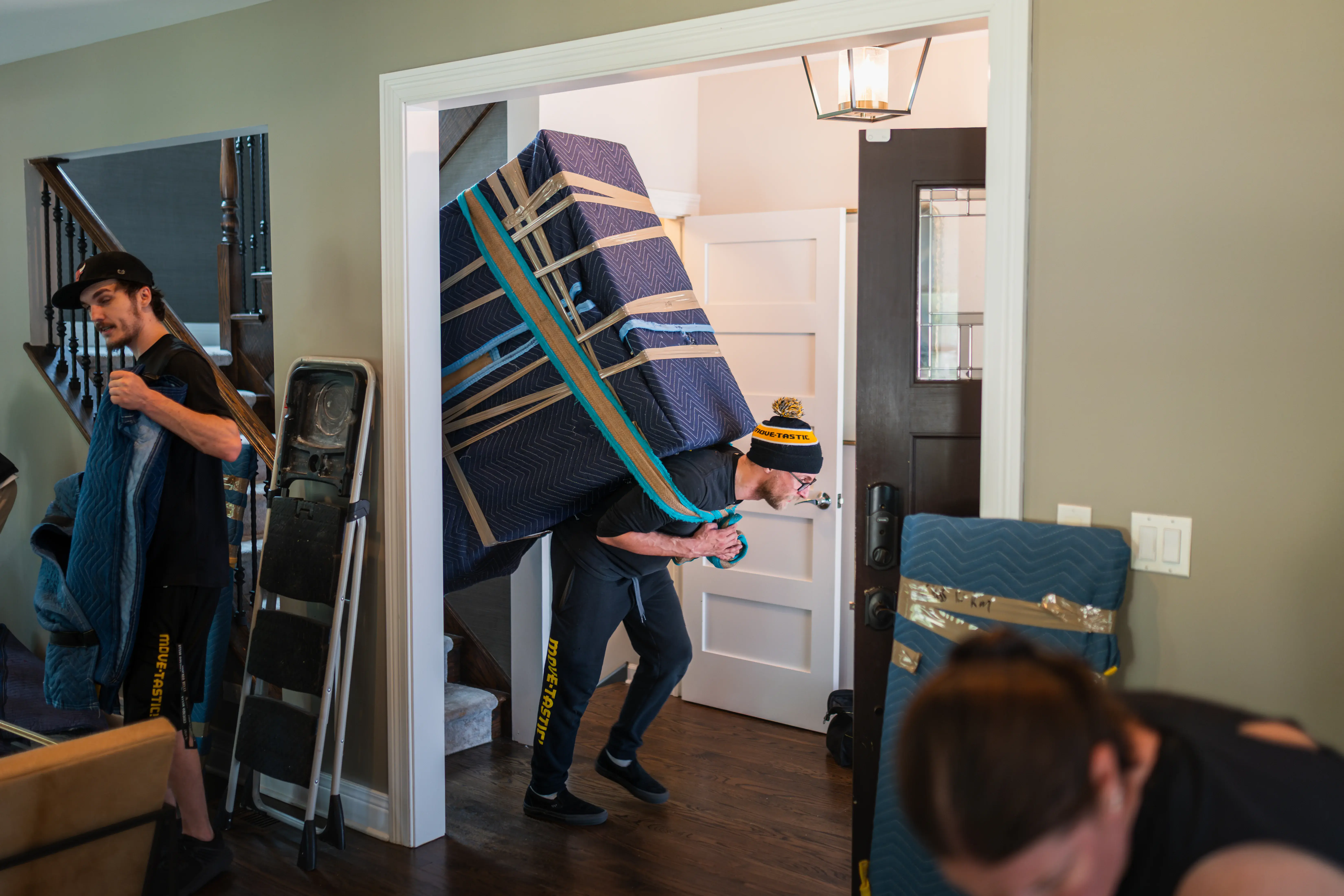 Mover carrying a large heavy item on their back during a move